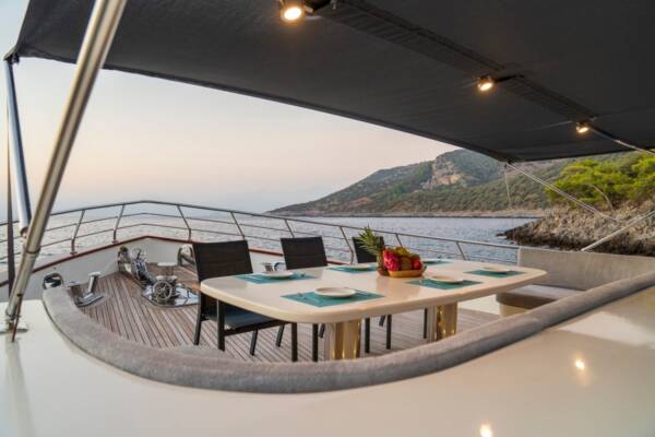 Enjoy intimate meals with panoramic Aegean views at the Alegria Trawler Yacht's charming bow deck dining table.