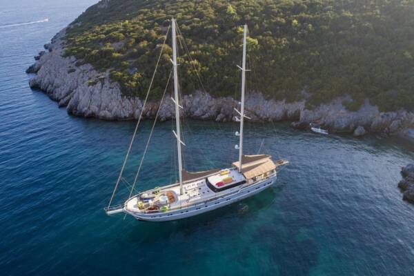 Luxurious Gulet Queen of Salmakis anchored in a tranquil bay, perfect for a relaxing getaway.