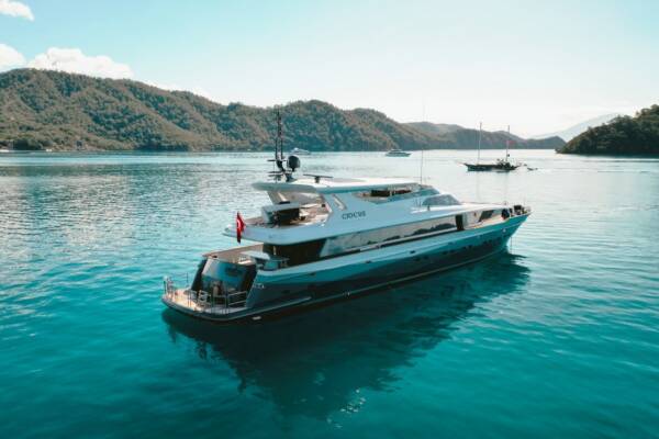 Luxury yacht Crocus, a beacon of elegance, anchors amidst traditional gulet yachts in Göcek Bay.