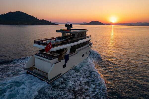 Trawler Albatros Explorer casts its elegant silhouette against a fiery Turkish sunset, promising an unforgettable evening of luxury and wonder.